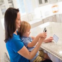 Mother and Daughter Capturing Check with Mobile Deposit