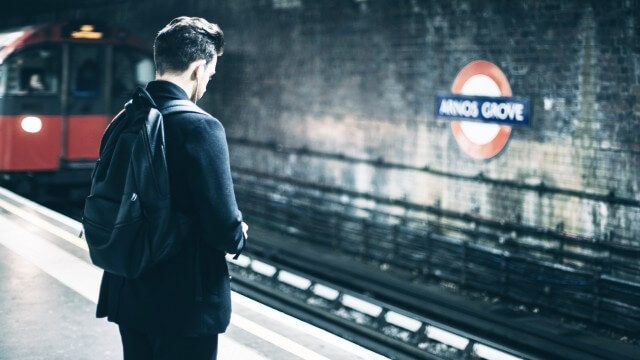 Man waiting on train in london