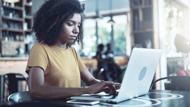 Woman on laptop behavioral biometrics